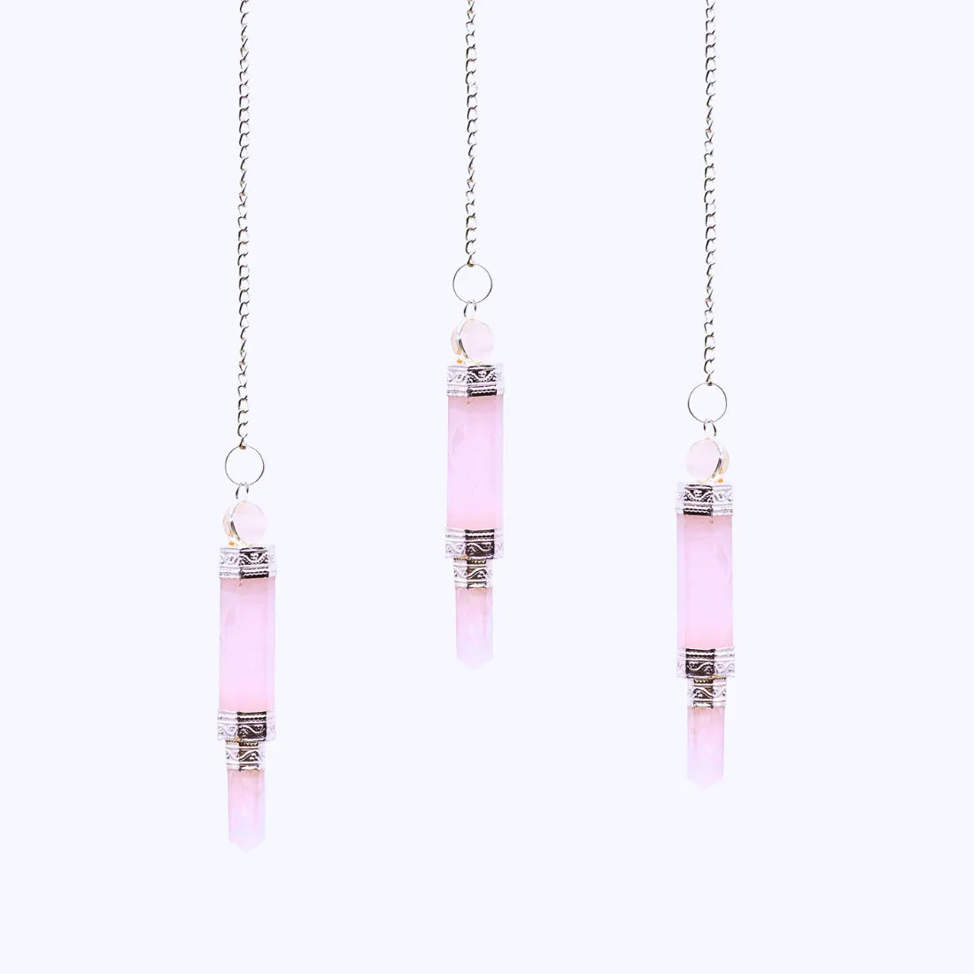 trois pendules double cristaux en quartz rose